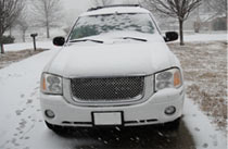 Parked car covered in snow