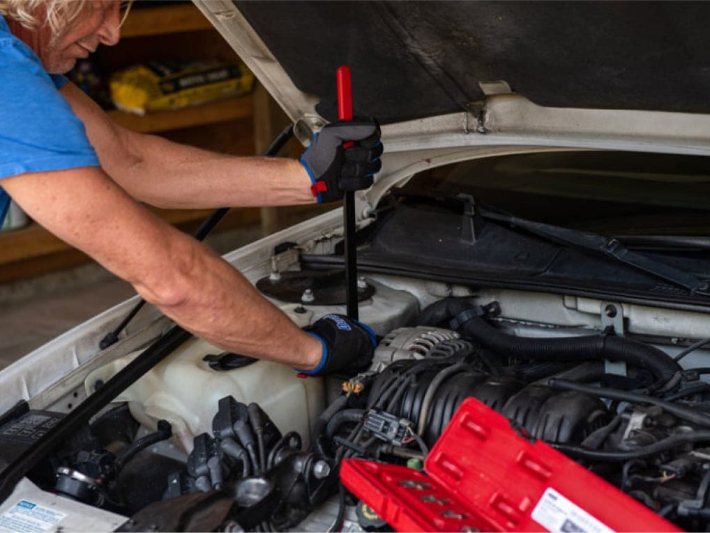 man working on alternator