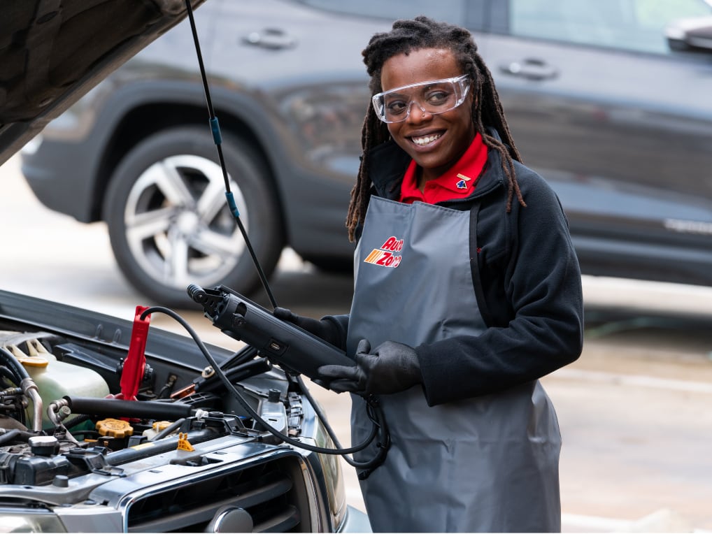 AutoZone employee testing a vehicle battery