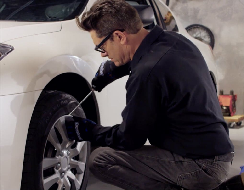 man working on brakes