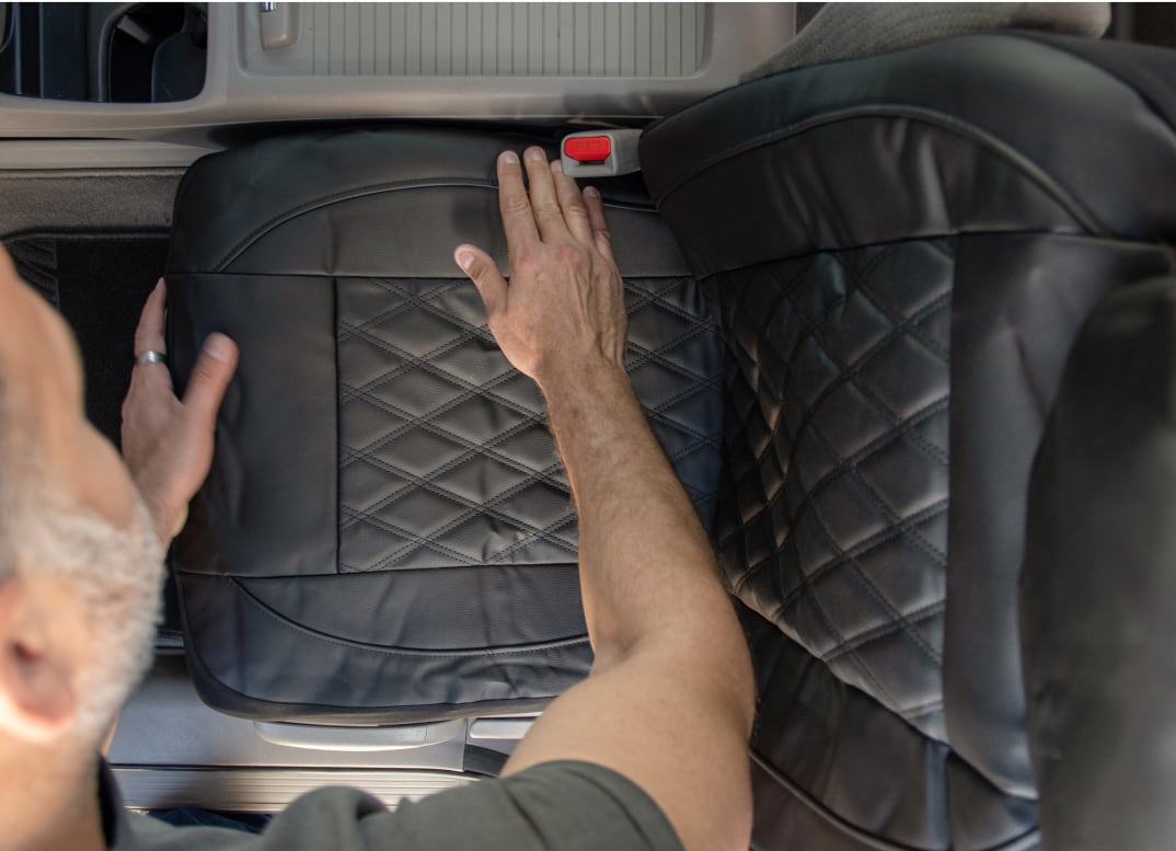 man installing a seat cover