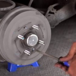A man showing how to change drum brakes.