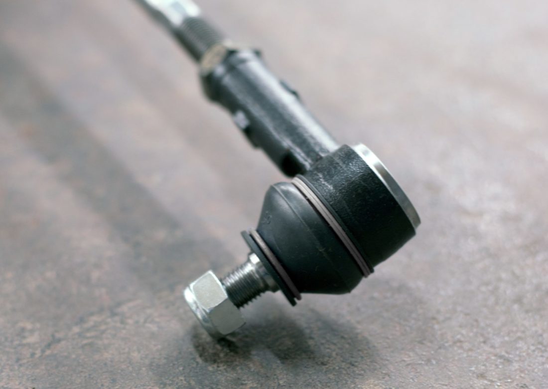 Tie rod end laying on top of the concrete.