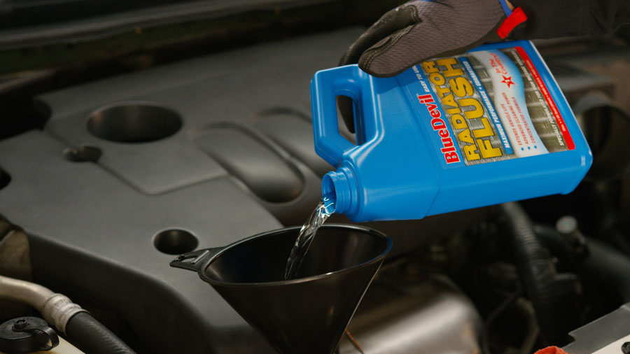 Person using Blue Devil radiator flush