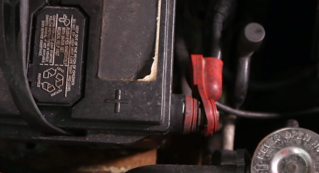 positive battery plus sign on old side post battery showing corrosion to terminal