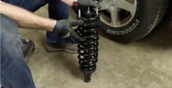 Person showing off a new Duralast loaded strut
