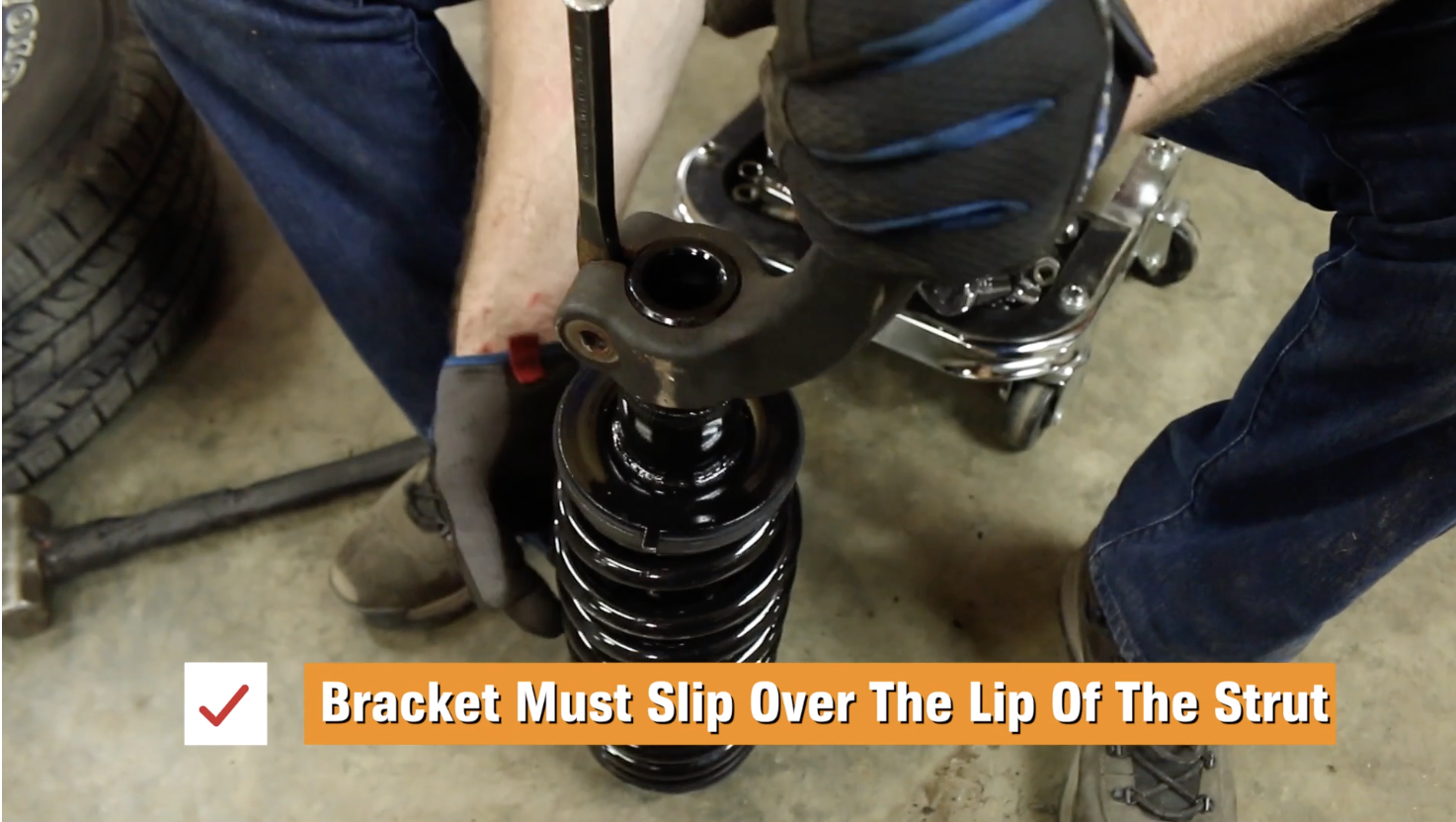 Person installing a mounting bracket onto a strut