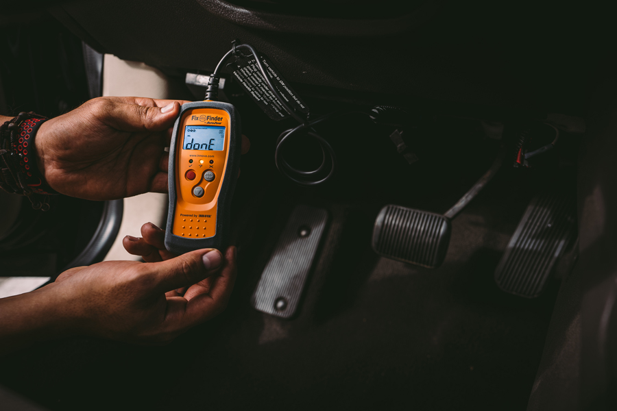 AutoZoner consulting his OBD reader and attempting to determine how to fix code P0011