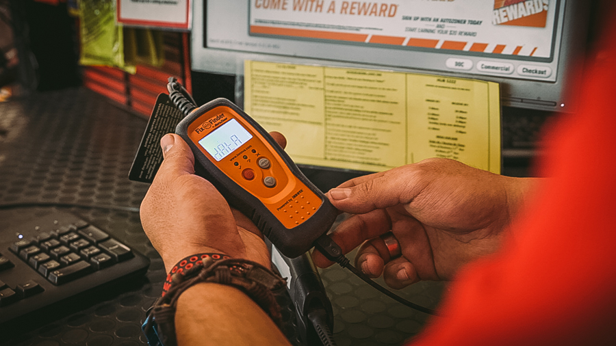 AutoZoner consulting his OBD reader and attempting to determine how to fix code p0136