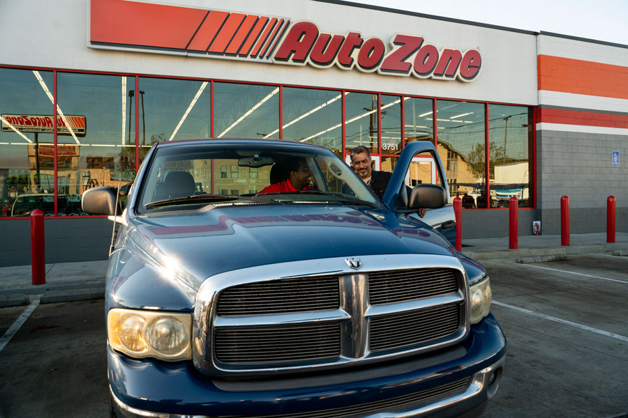 AutoZone associate using Fix Finder scan tool to diagnose P2002