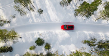 This car is passing through two snow banks as the owner was ready for winter