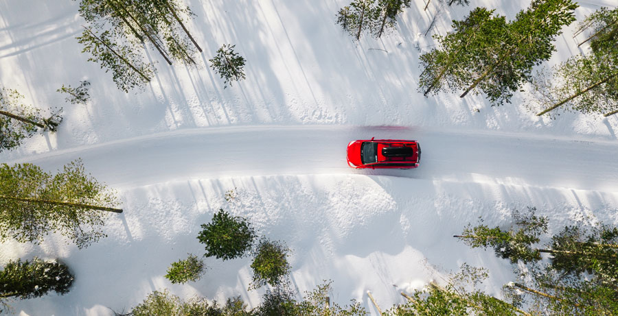 This car is passing through two snow banks as the owner was ready for winter