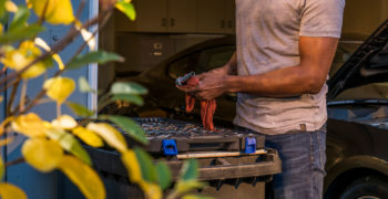 Man cleaning tools while working on his car