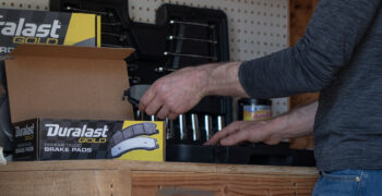 autozone brake fluid with duralast brake pads on work bench 2