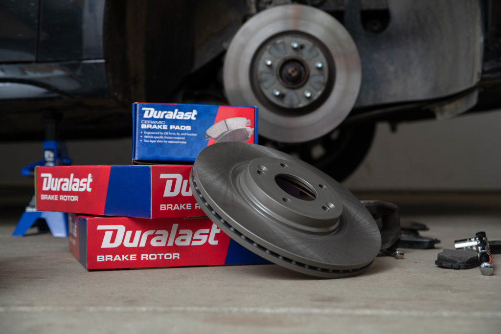 Duralast rotor and boxes in foreground car with wheel off in background