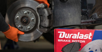 Duralast rotor box duralast brake pads brake job being performed in background