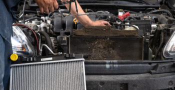 mechanic disasembling vehicle for ac kit install with ac kit in foreground 11