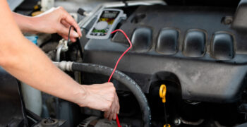 multimeter being used to test alternator 1