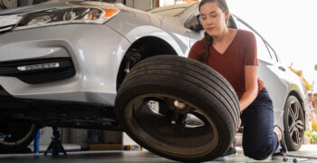 woman removing tire from car 3 1