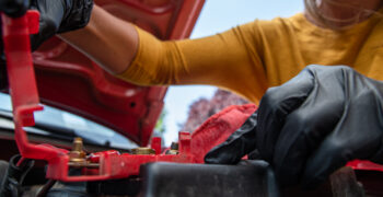 close up woman inspecting battery terminal