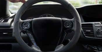 pro elite steering wheel cove installed on steering wheel with hand