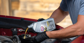 oil change stp oil 1 qt pouring oil into funnel